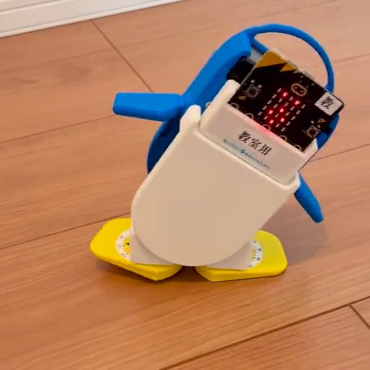 micro:bitをのせたペンギン型のロボットが歩く様子